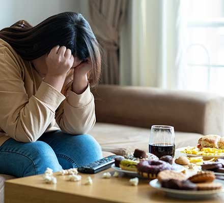 A woman is tired and sick of stress eating
