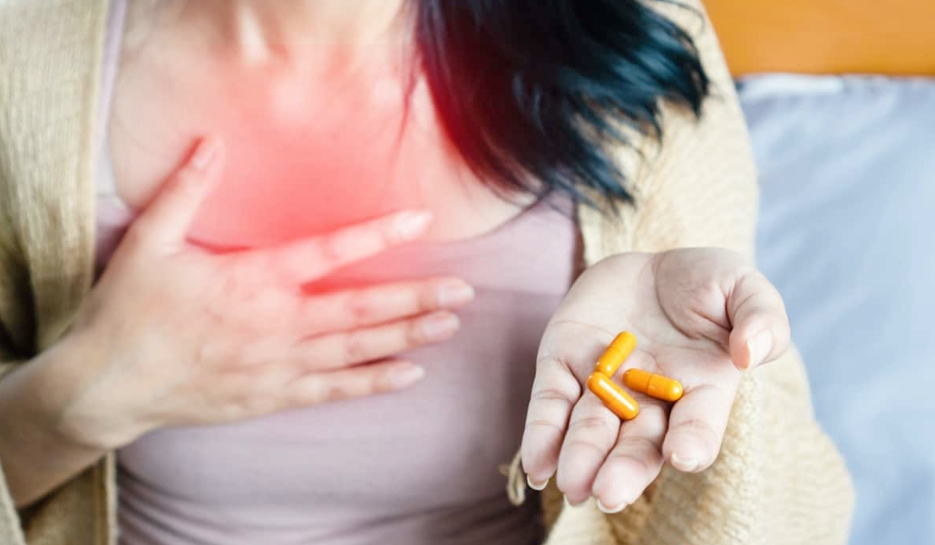 women suffering from pill induced heartburn